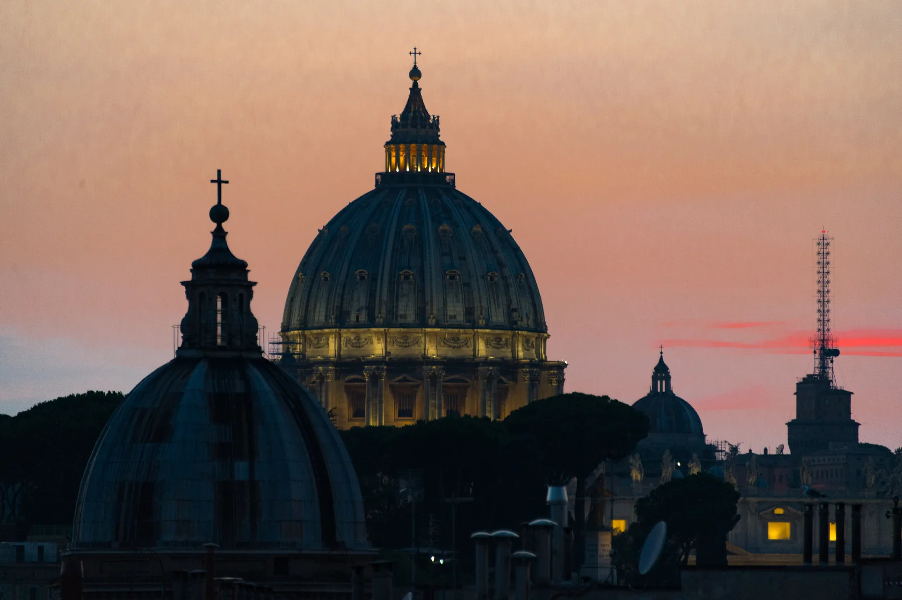 Cupola di San Pietro illuminata al tramonto con cielo rosato