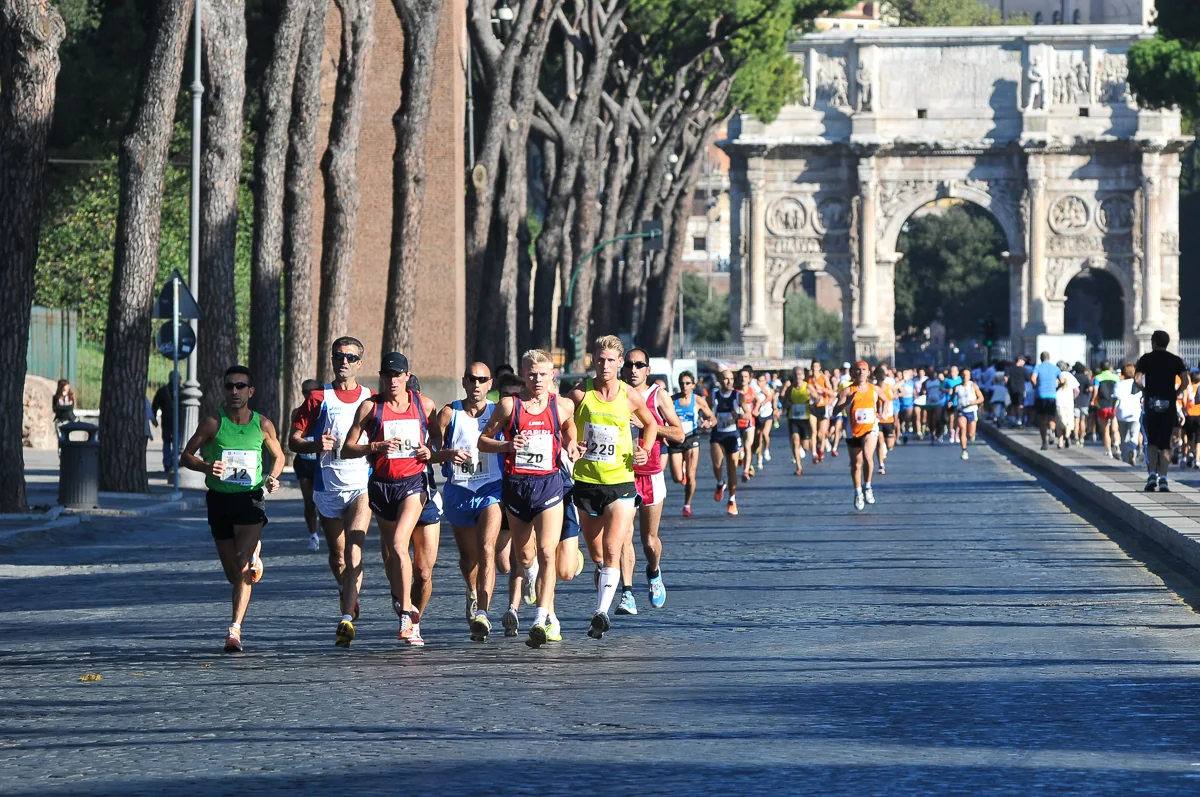 Runner durante una gara su strada a Roma con l’Arco di Costantino sullo sfondo